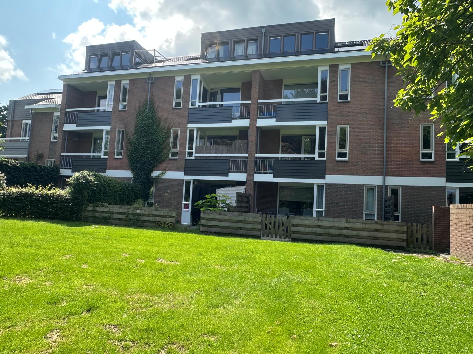 Door Raanhuis Bouw uitgevoerd vastgoedonderhoud aan de achtergevel van een woning aan de Thoomsenweg in Neede, met aangrenzende groenstrook.